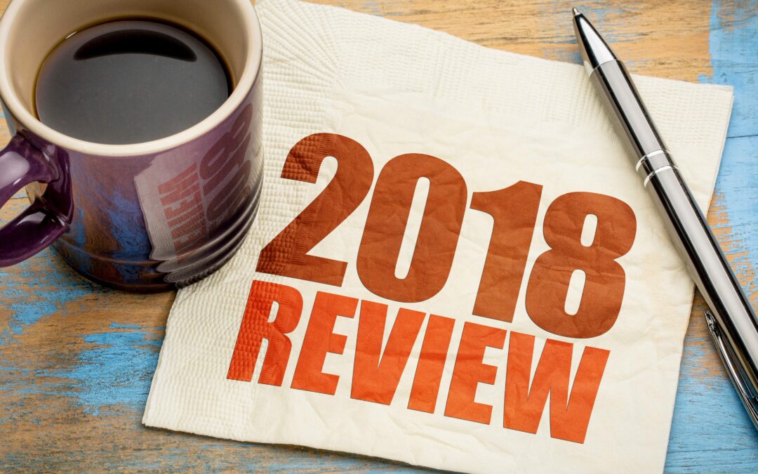 2018 review napkin on desk with pen and mug