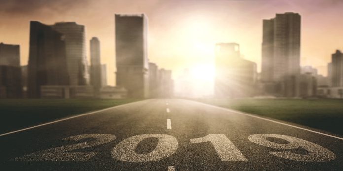 road with city in background with 2019 painted on pavement