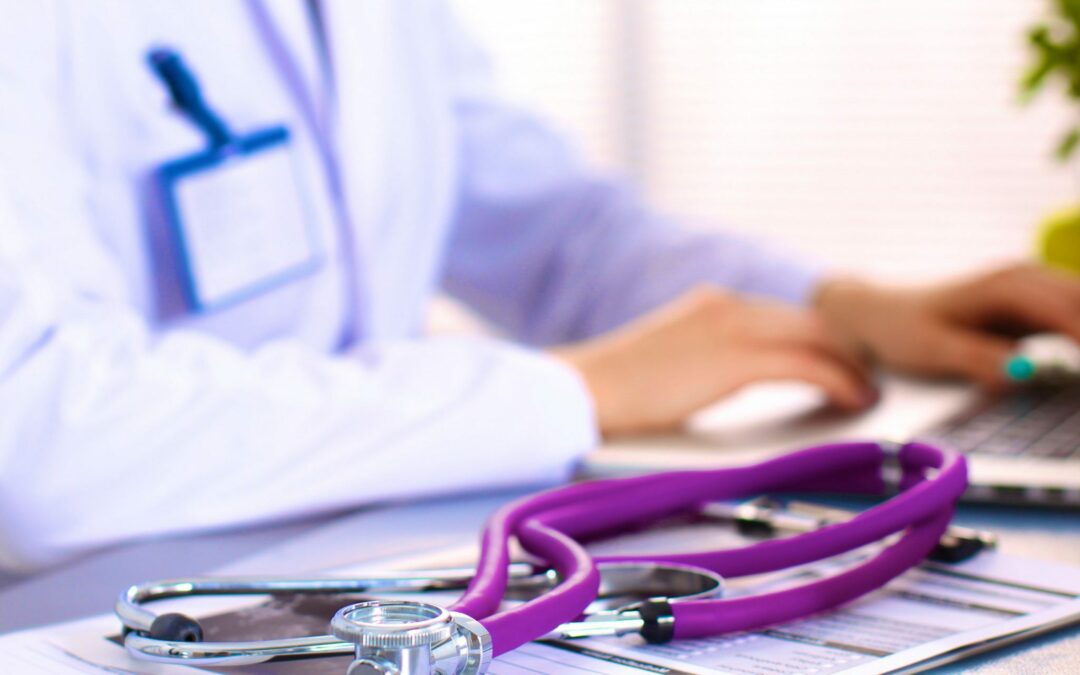 Doctor at desk with stethoscope in close focus