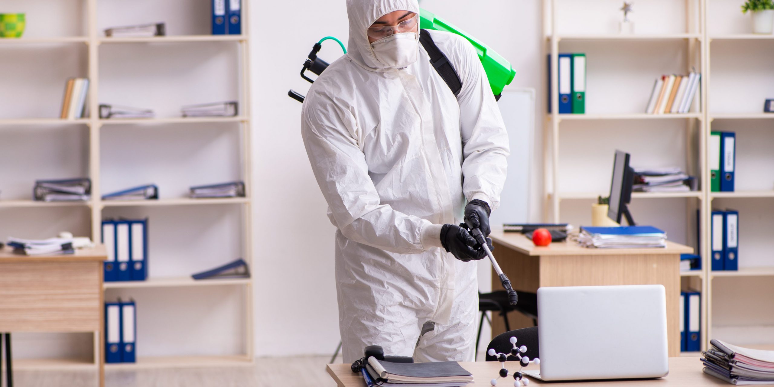 Corporate worker Sanitizing office space