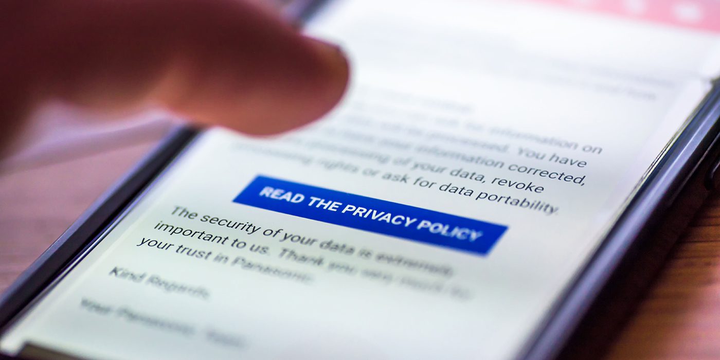 Mobile phone with blue read the privacy policy button on screen