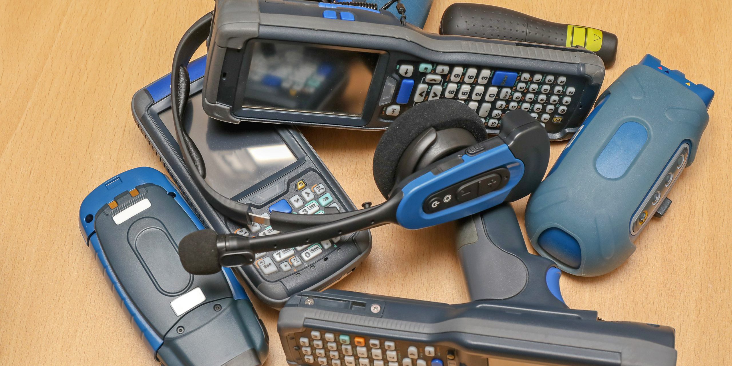 closeup of barcode guns and headset on desk