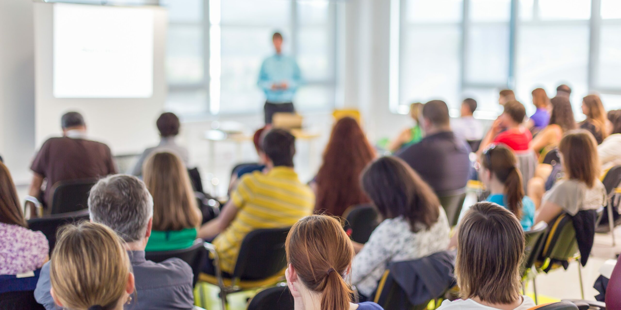classroom of adults listening to public speaker