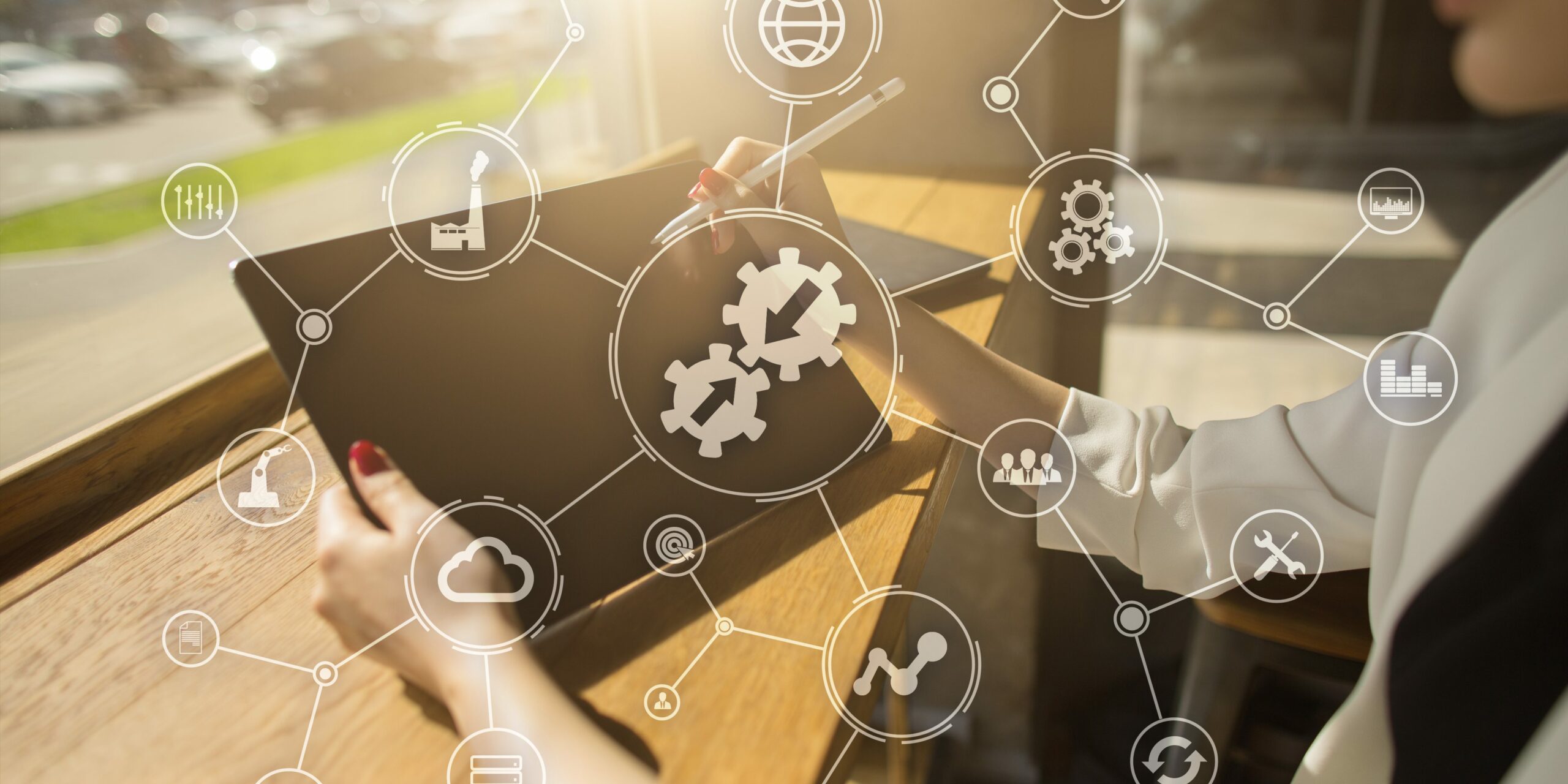 woman holding tablet on table with security and data icons