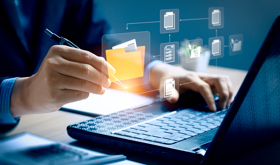 Laptop with documents on desk. RIM Program.